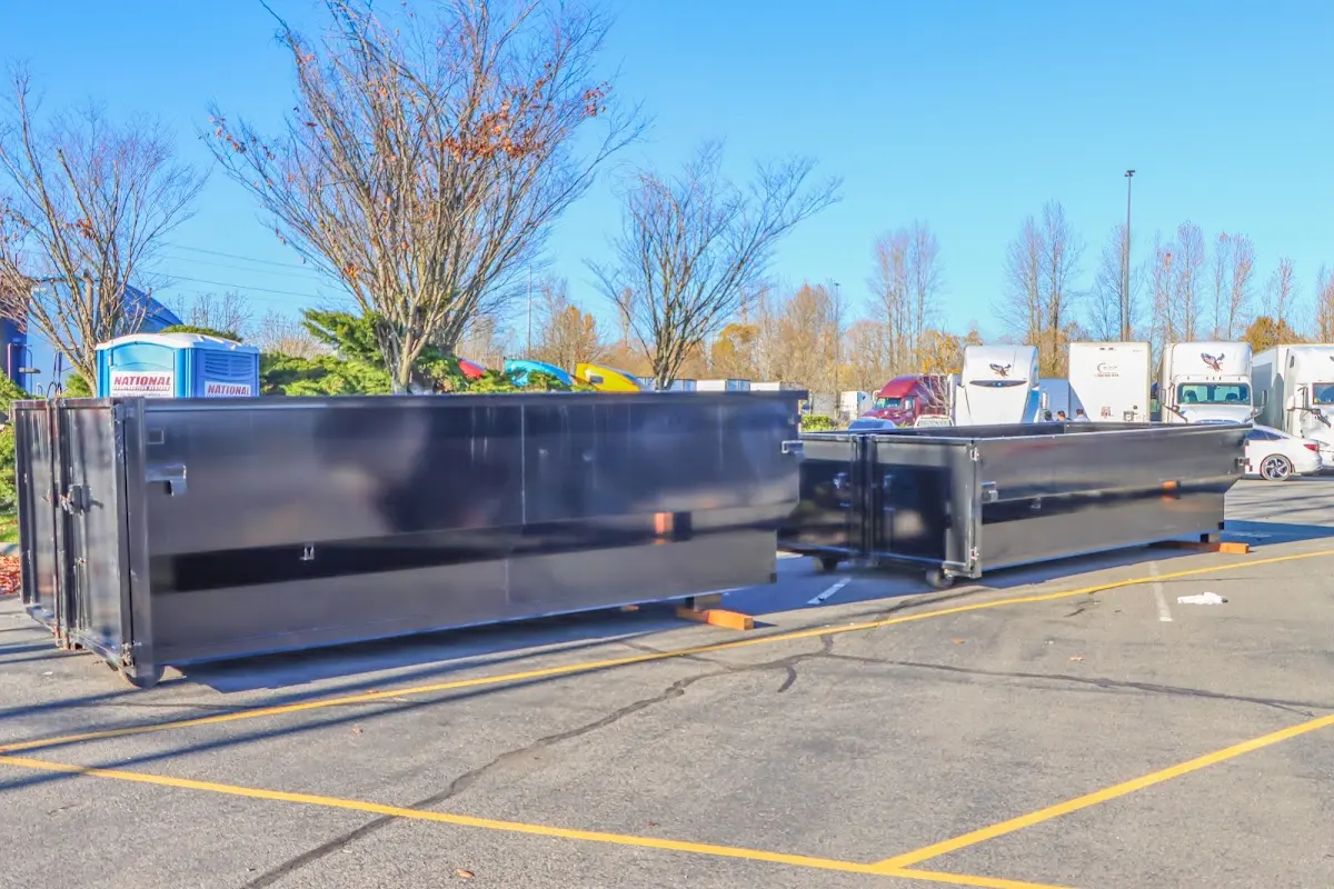 Professional dumpster rental service with roll-off container on residential driveway in Big Spring